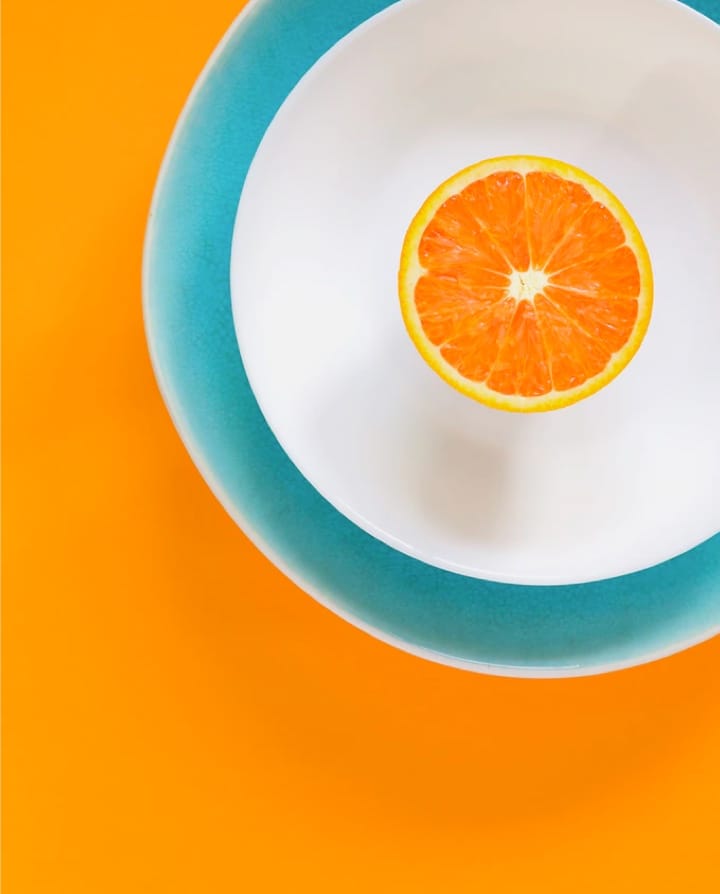 an orange in a plate